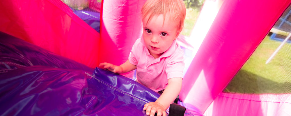 Young boy climbing up bouncy castle slide in Victoria, BC