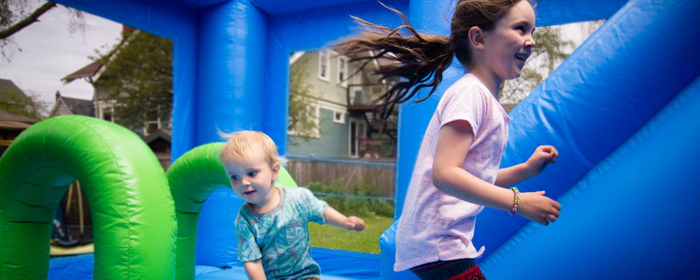 Girl and boy jumping on bouncy castle in Victoria, BC